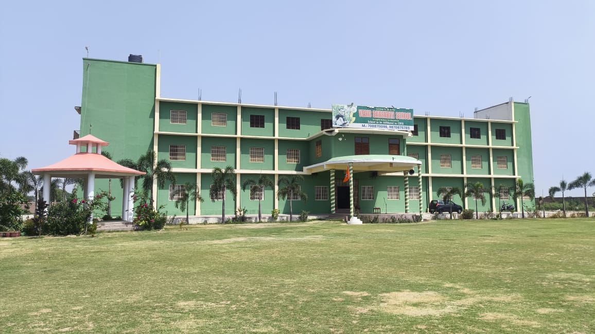 The green academic block of Vedic Sanskriti School, with its front lawn, entrance porch and gazebo, at Village Dausa, Modinagar.